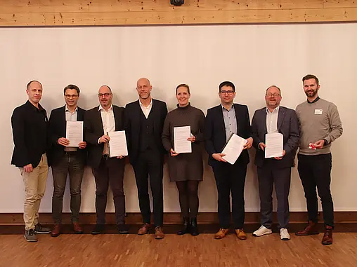 Personen halten Zertifikate.